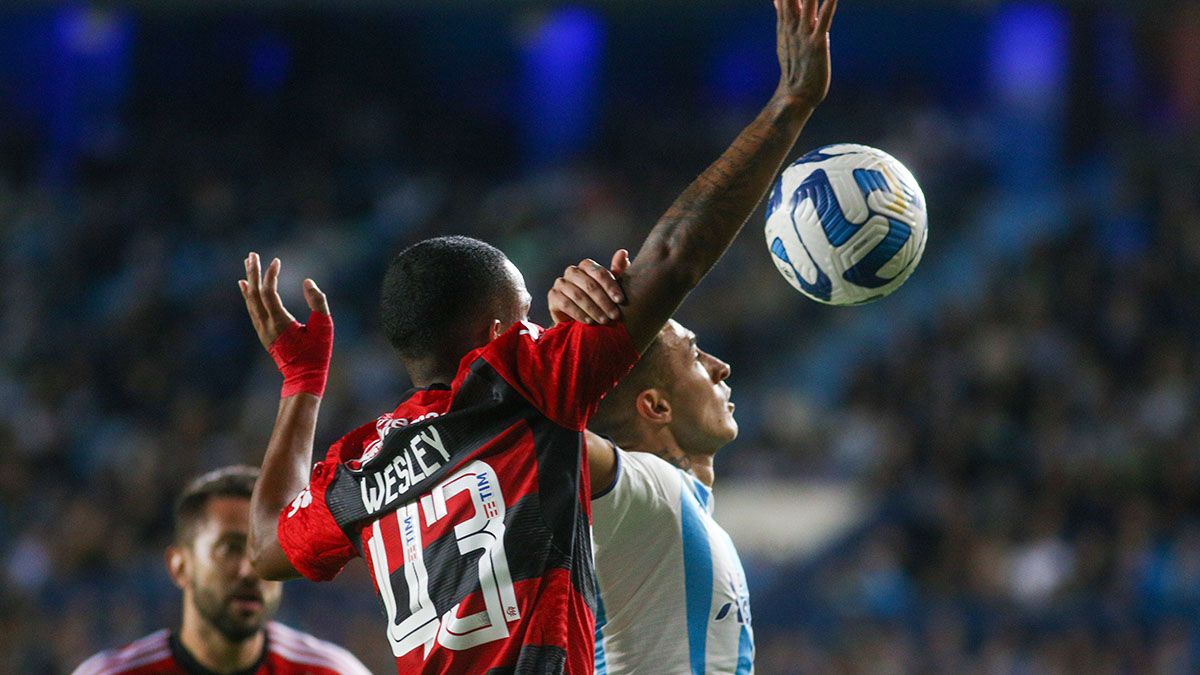 Ayrton Lucas of Flamengo heads the ball against Matias Rojas of